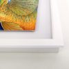 Side view of white picture frame.