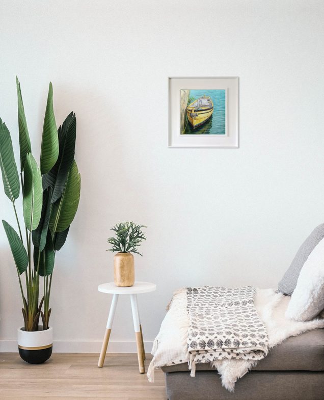Painting of fishing boat hanging in a room