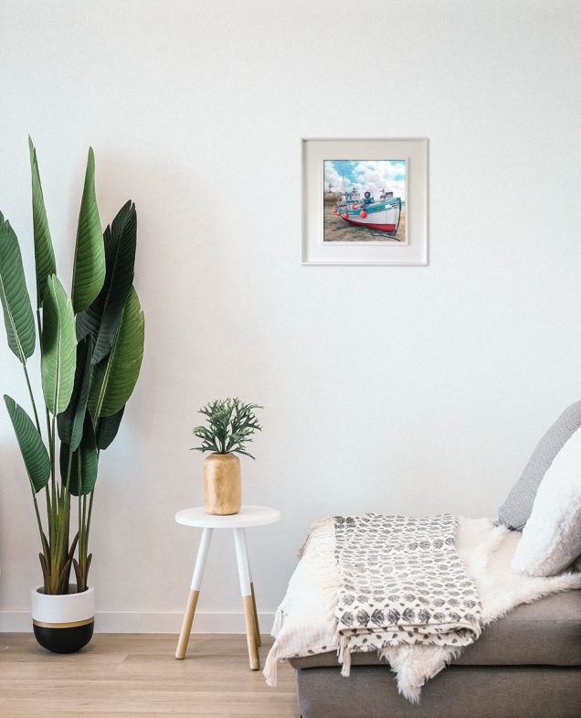 Painting of a fishing boat hanging in a room