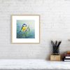 Print of a blue tit in an oak picture frame and white mount